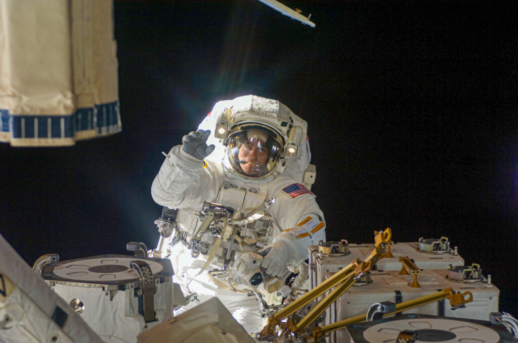 NASA Astronaut Chris Cassidy performing one of his 10 career spacewalks outside the International Space Station. Pictured in a white Extravehicular Mobility Unit (EMU), he works to maintain and upgrade station systems, contributing to his nearly 55 total hours of experience in the vacuum of space.